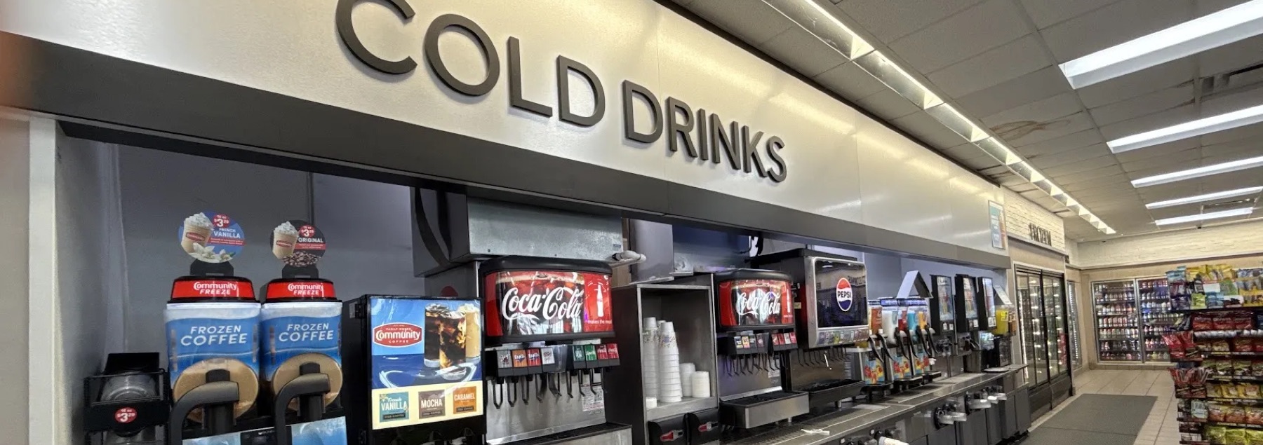 Cold drinks bar with Community frozen coffee, Coca-Cola and Pepsi fountains and slushie machines