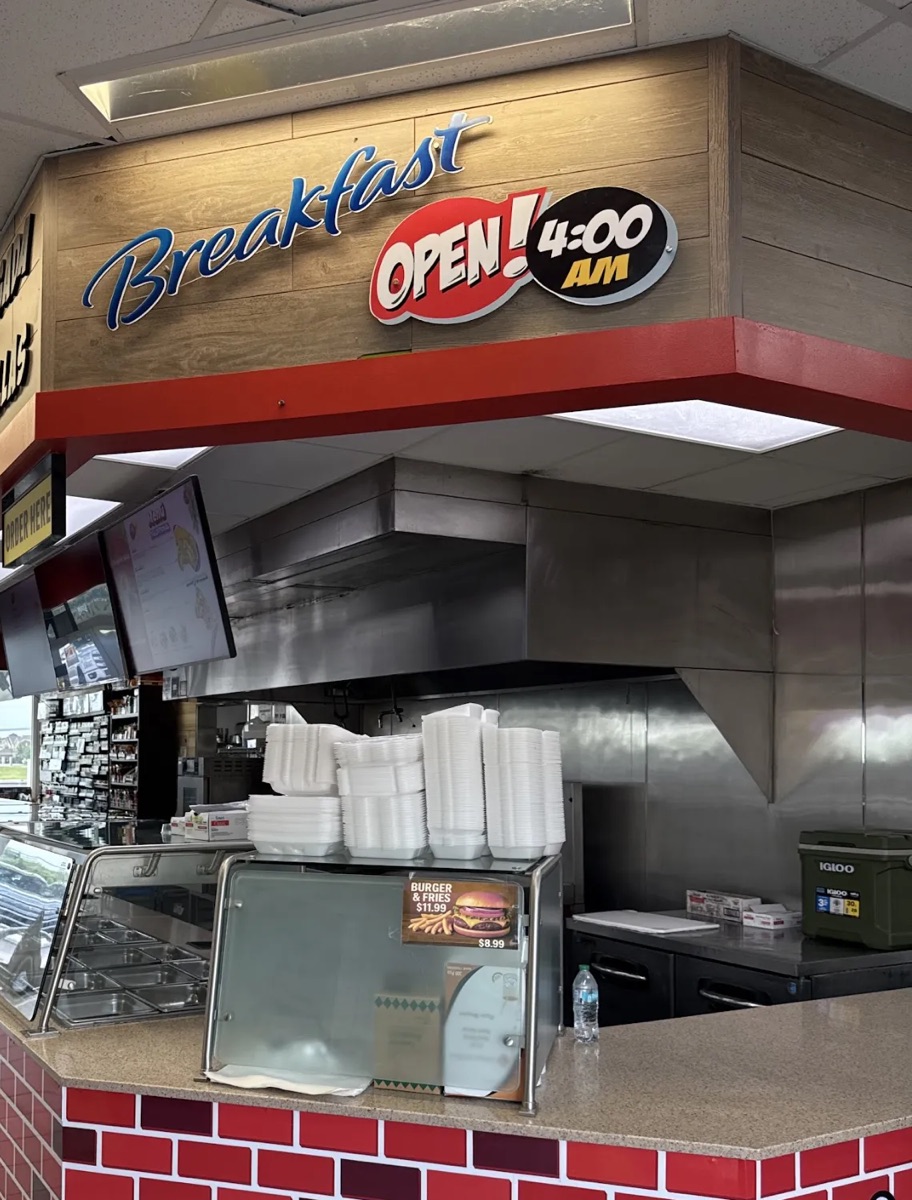 Food counter with a Breakfast sign, open at 4:00 AM, and a red brick counter