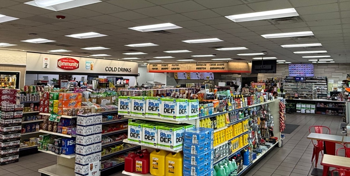 Store aisles with snacks, motor oil and DEF, plus café seating by the windows